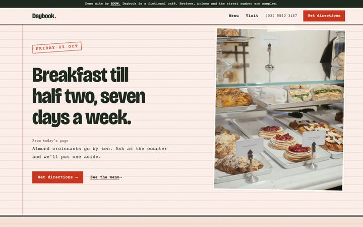 The Daybook home page on a laptop: a red date stamp and the opening hours on ruled paper, beside a taped photo of the pastry counter.