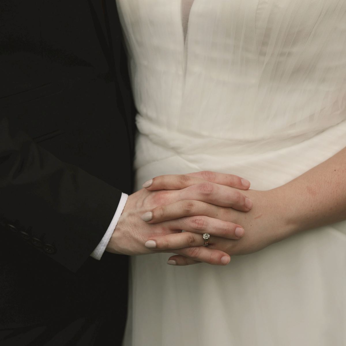 Callum's hands folded over Priya's at her waist.